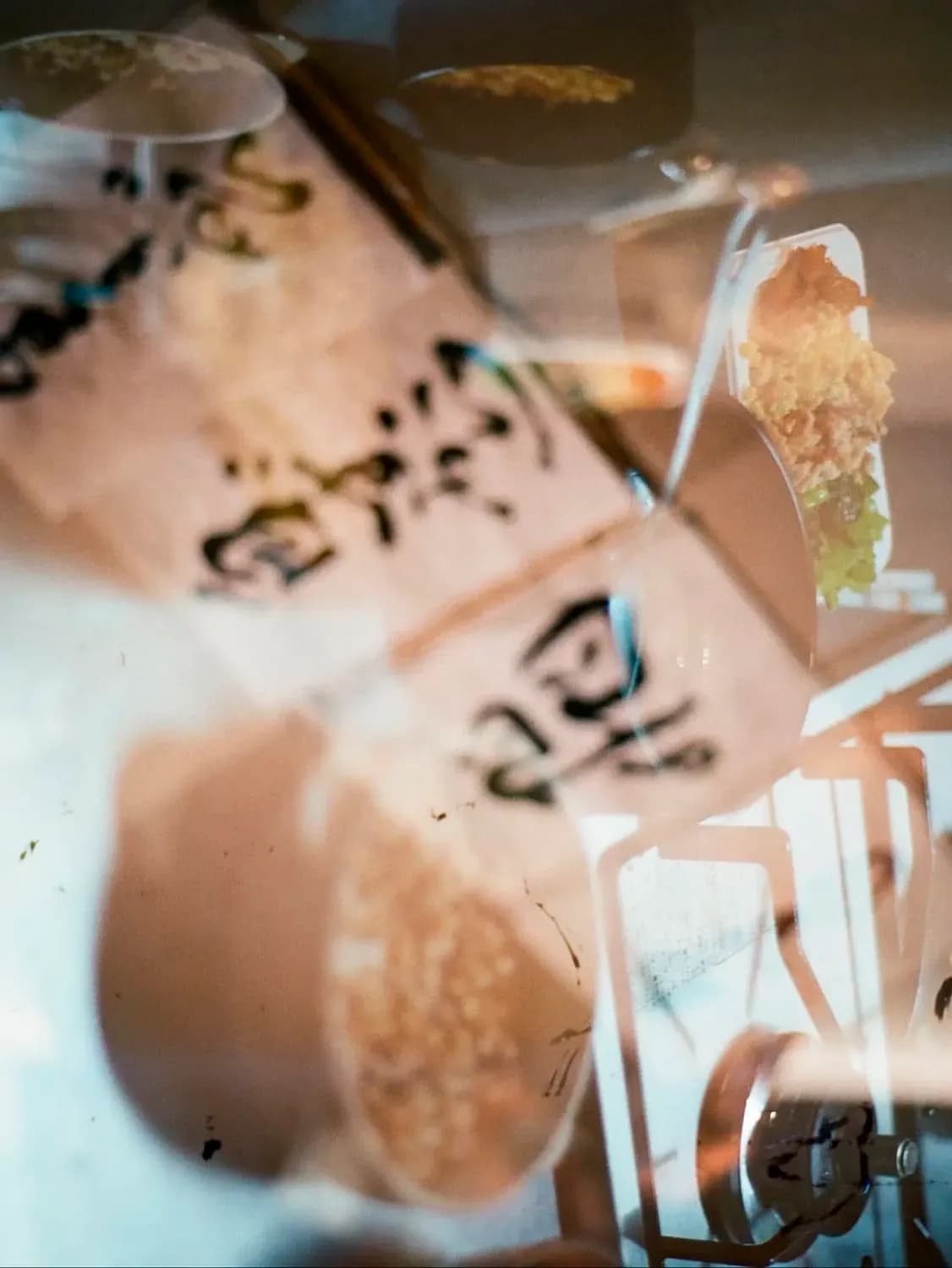 Artistic overlay of food and tableware, showing plated dishes and utensils with a warm, abstract double-exposure effect.